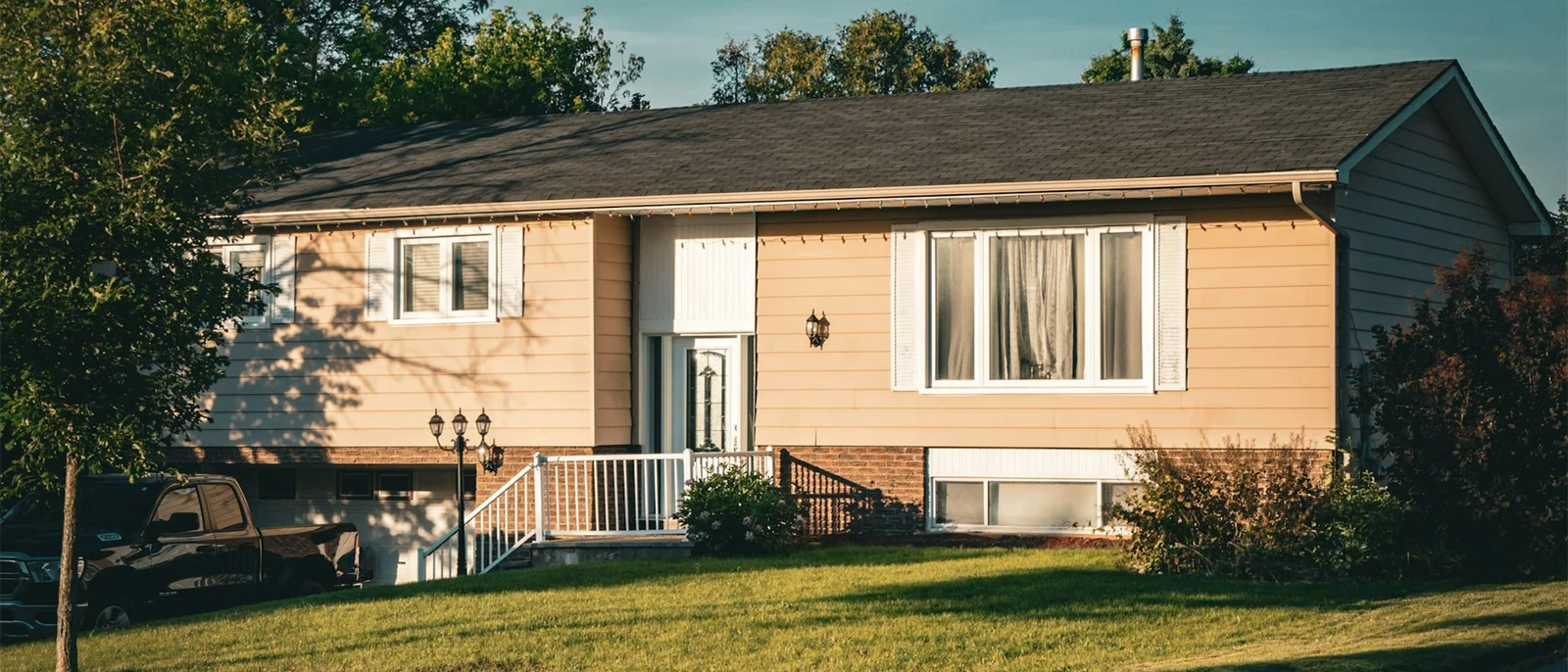 A welcoming neighborhood home in warm evening light